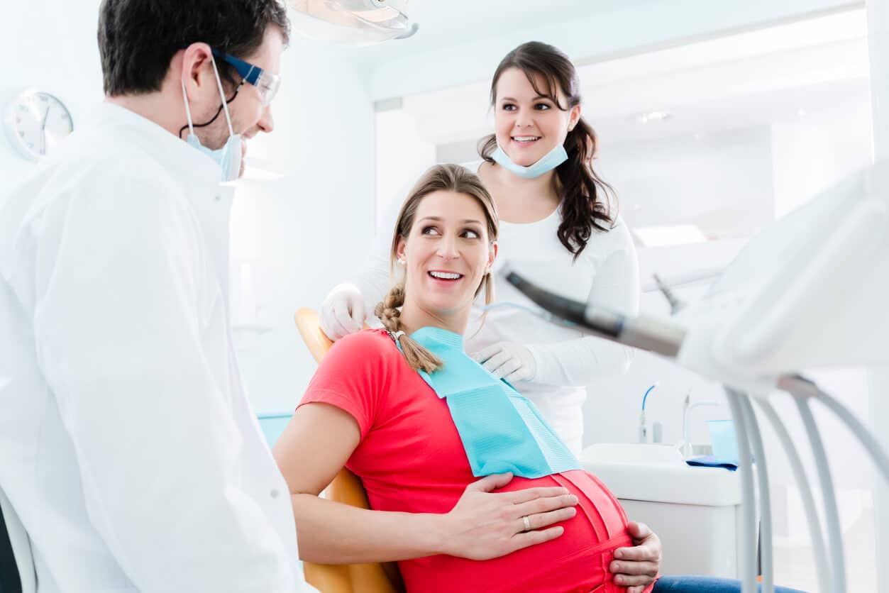 Pregnant woman at dentist before dental x-ray.
